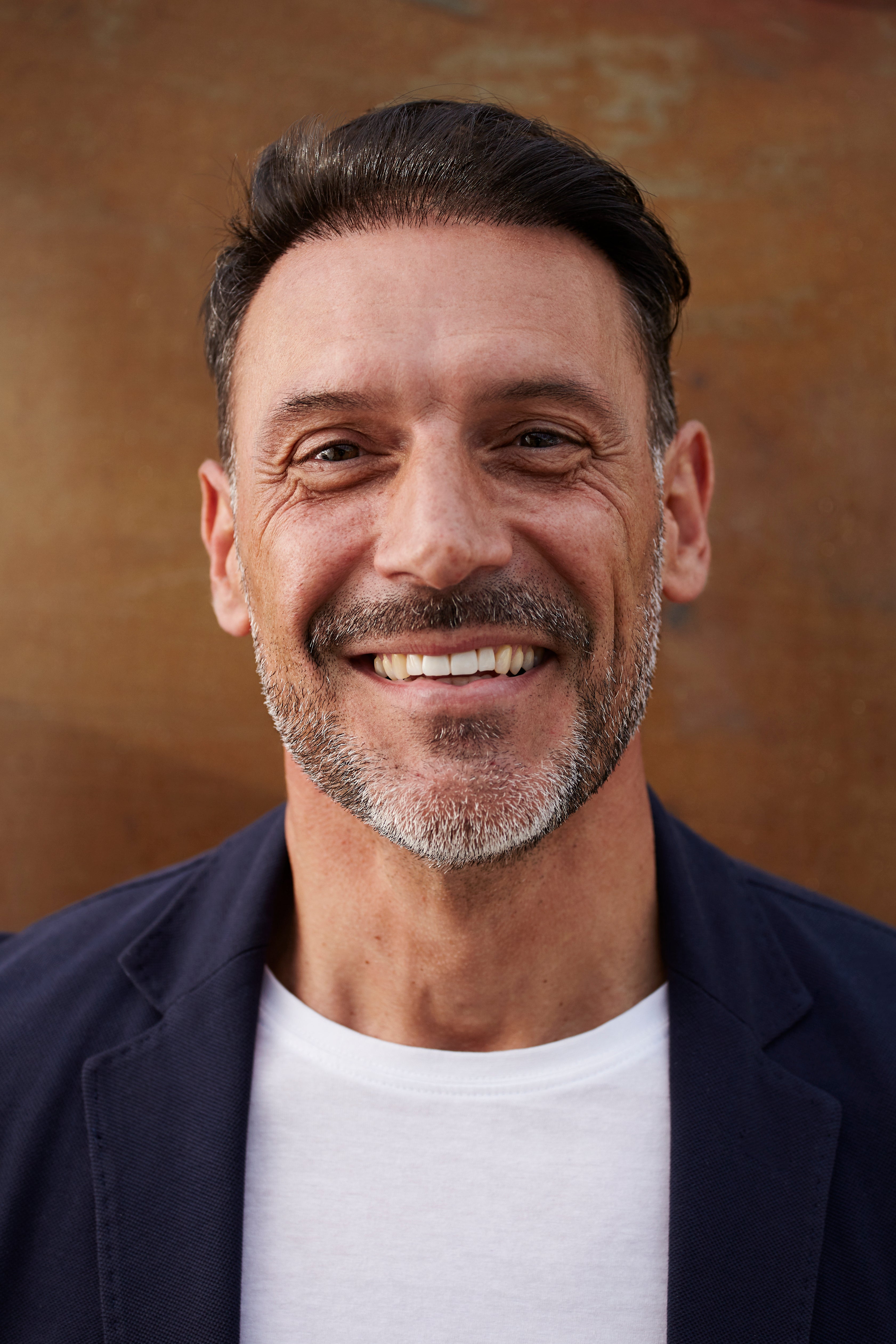 files/middle-aged-man-wearing-jacket-laughing-happy.jpg
